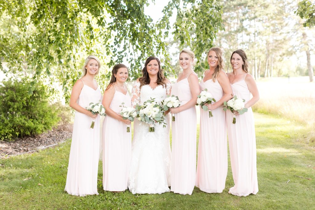 bridesmaids outside in blush dresses at Lake Wissota Golf & Events