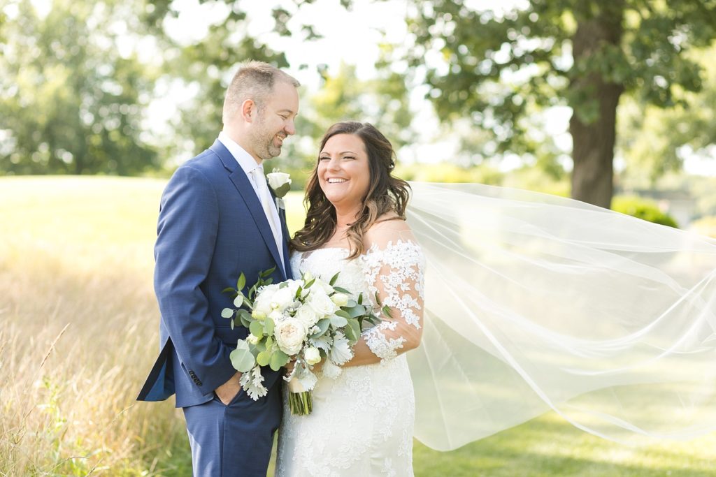 couple smiling and laughing at their wedding at Lake Wissota Golf & Events