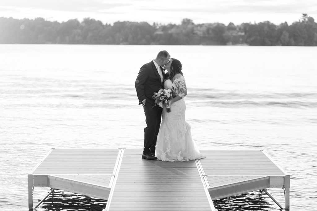 couple on the dock on their wedding day at Lake Wissota Golf & Events