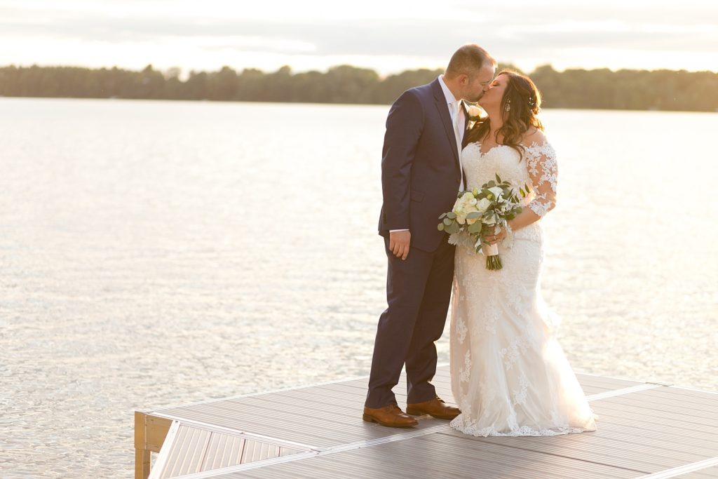 couple on the dock on their wedding day at Lake Wissota Golf & Events