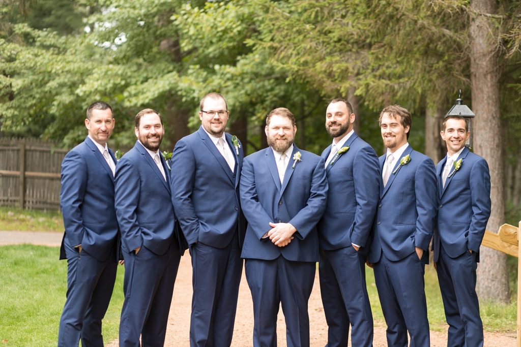 groom with groomsmen in blue suits at The Beacons in Minocqua