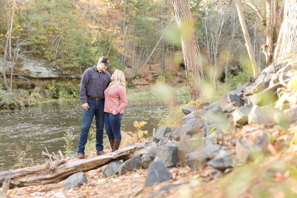 couple near Duncan Creek at Erickson Park in Chippewa Falls for their engagement session