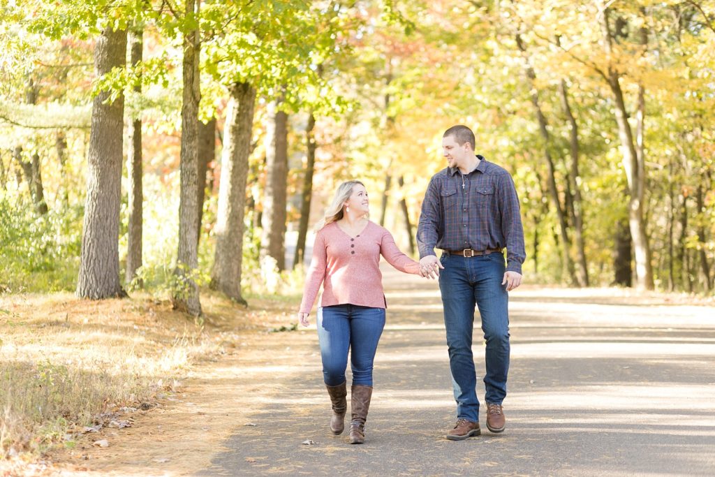 couple walking through Irvine Park in Chippewa Falls at their engagement session