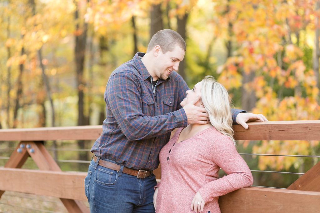 couple looking at each other and smiling at Erickson Park in Chippewa Falls for their engagement session