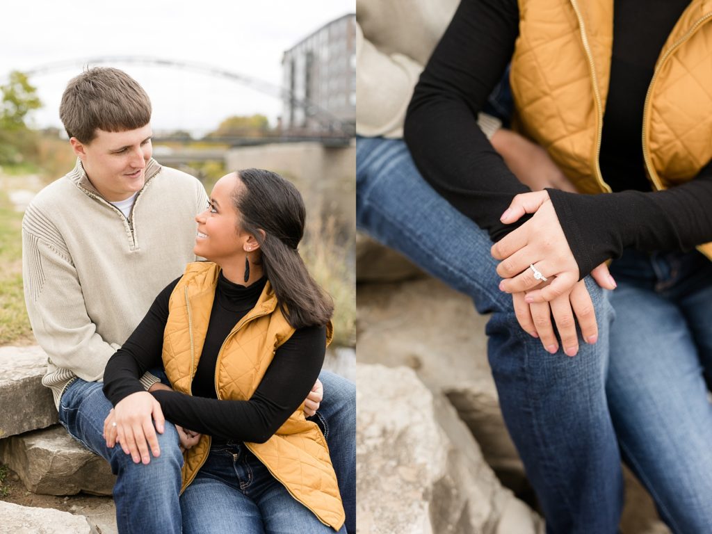 couple sitting on rocks at the Phoenix Park in Eau Claire for their engagement photos