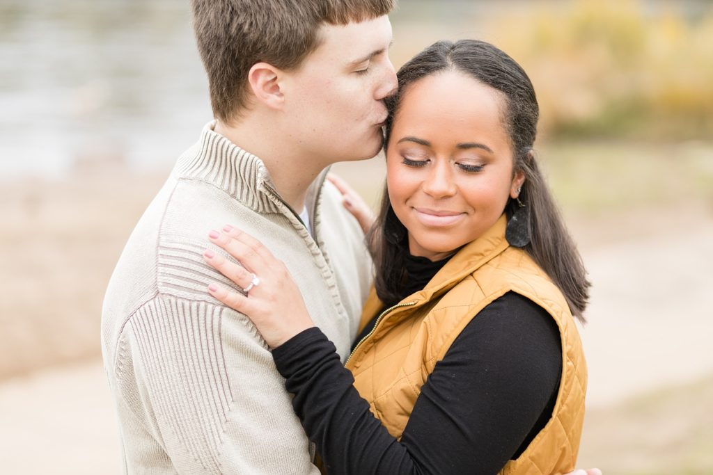 groom kissing brides forehead in Eau Claire for their engagement photos
