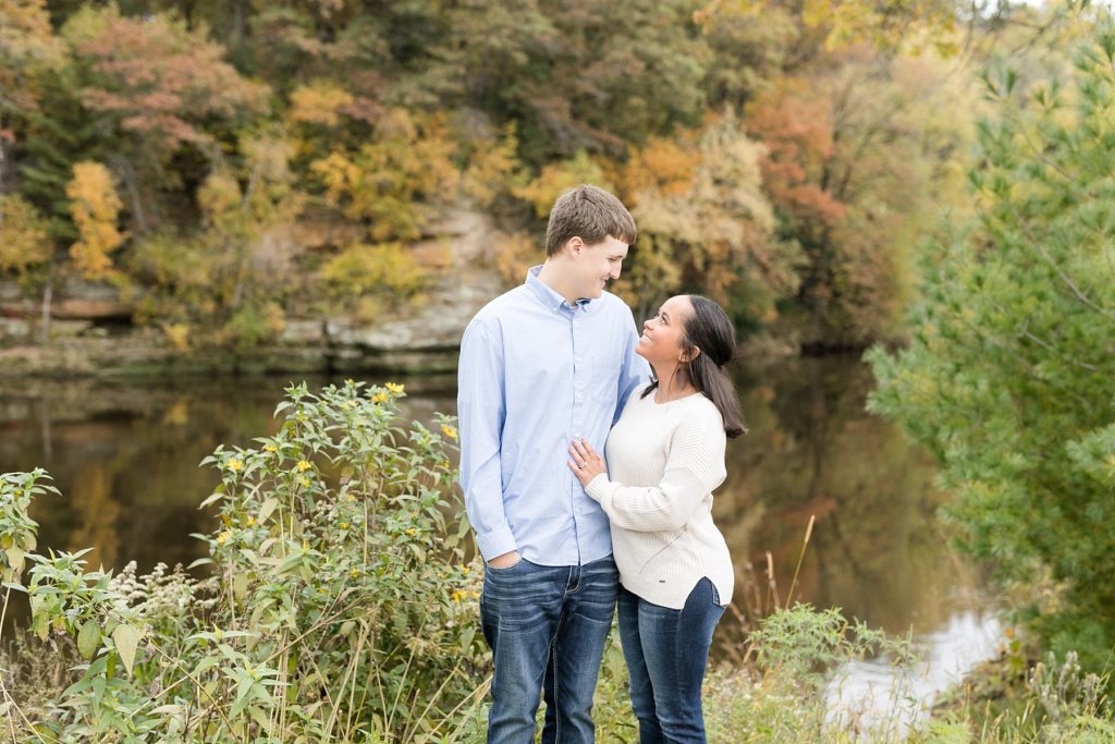 couple overlooking the river at River Prairie in Eau Claire for their engagement photos