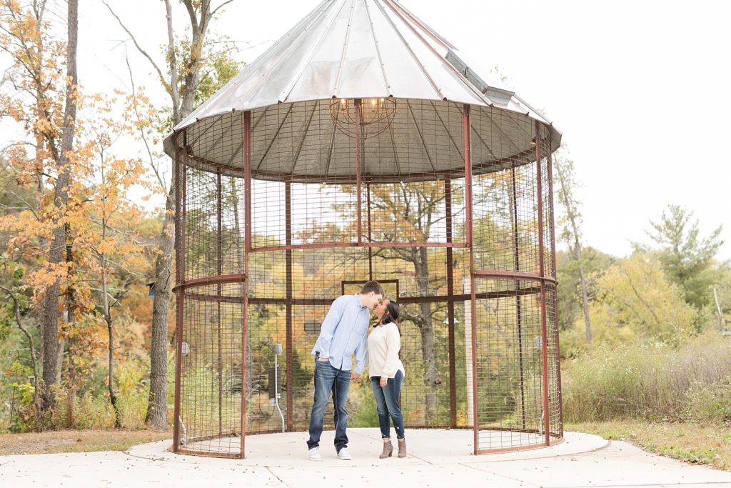 couple in the corn crib kissing at River Prairie in Eau Claire for their engagement photos