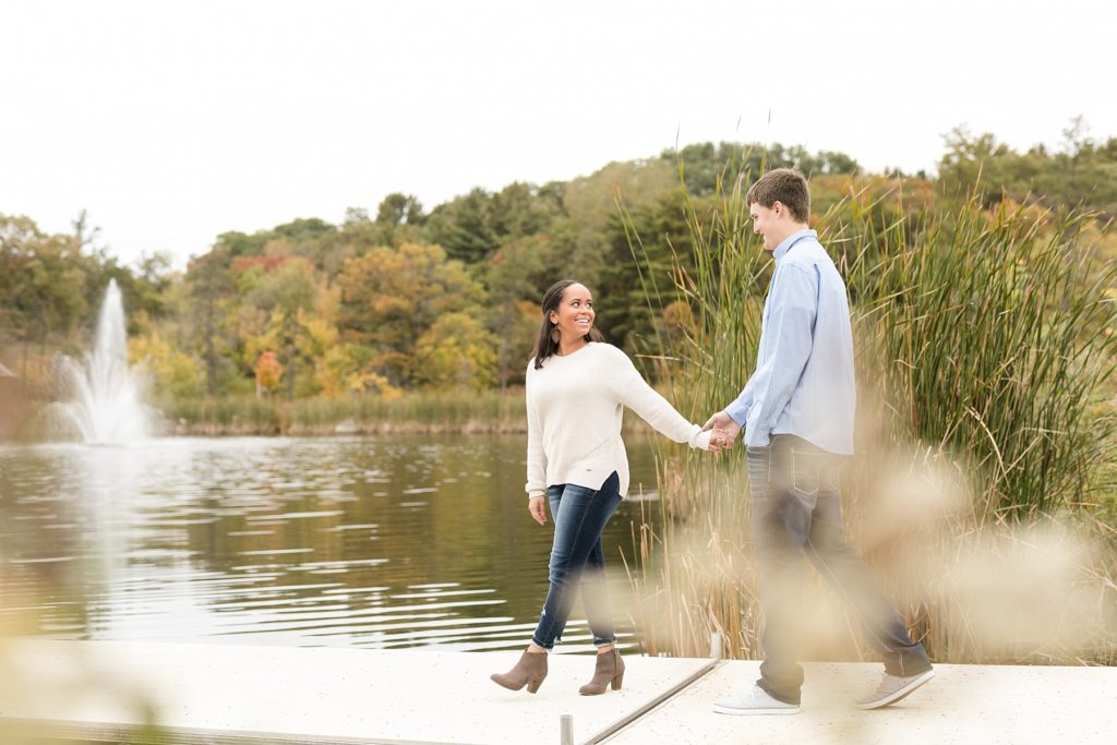 couple on the dock at River Prairie in Eau Claire for their engagement photos