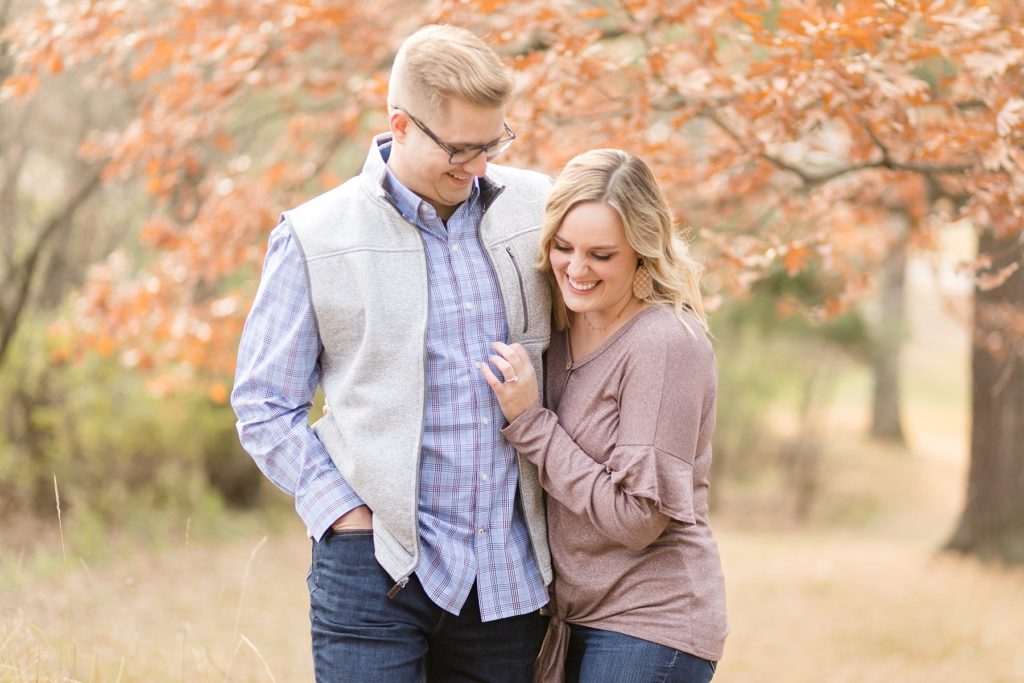 couple laughing for their late fall Irvine Park engagement photos in Chippewa Falls