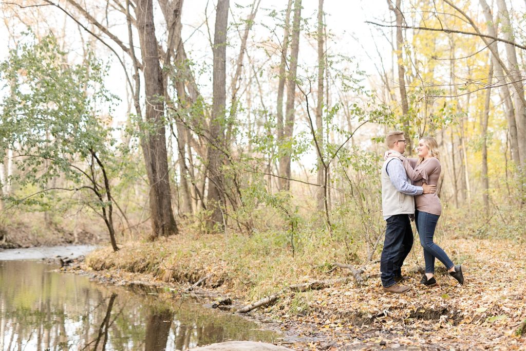 couple near the water for their late fall Irvine Park engagement photos in Chippewa Falls