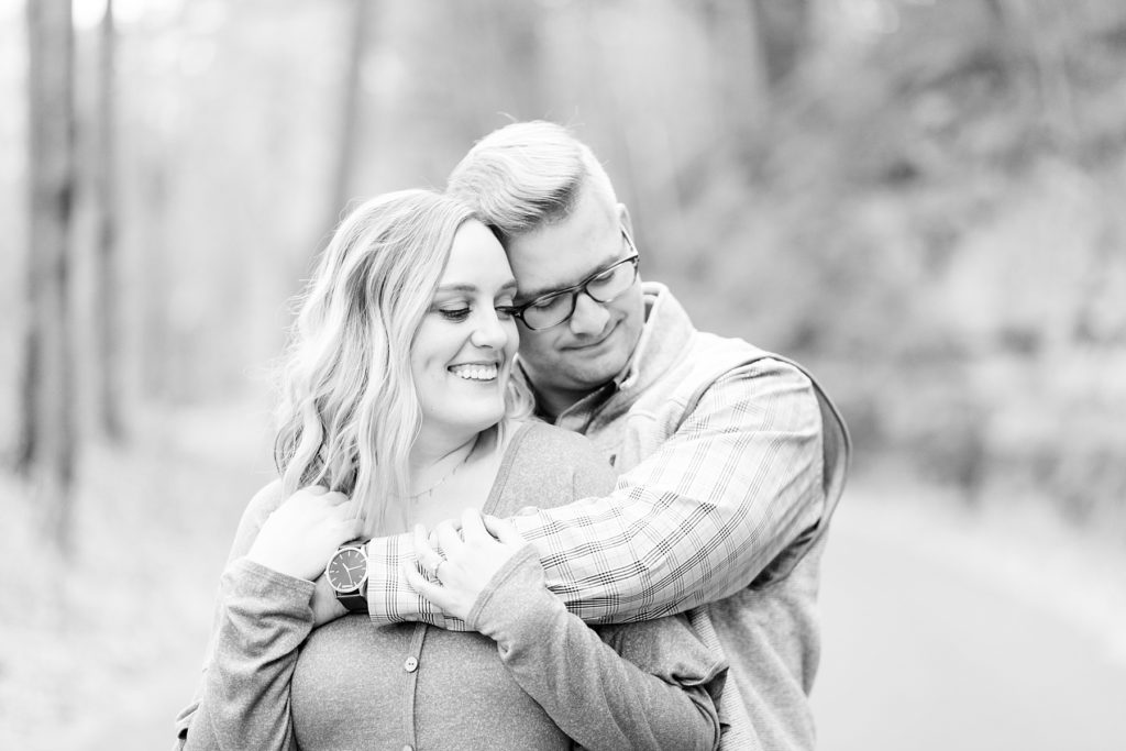 couple hugging for their late fall Irvine Park engagement photos in Chippewa Falls