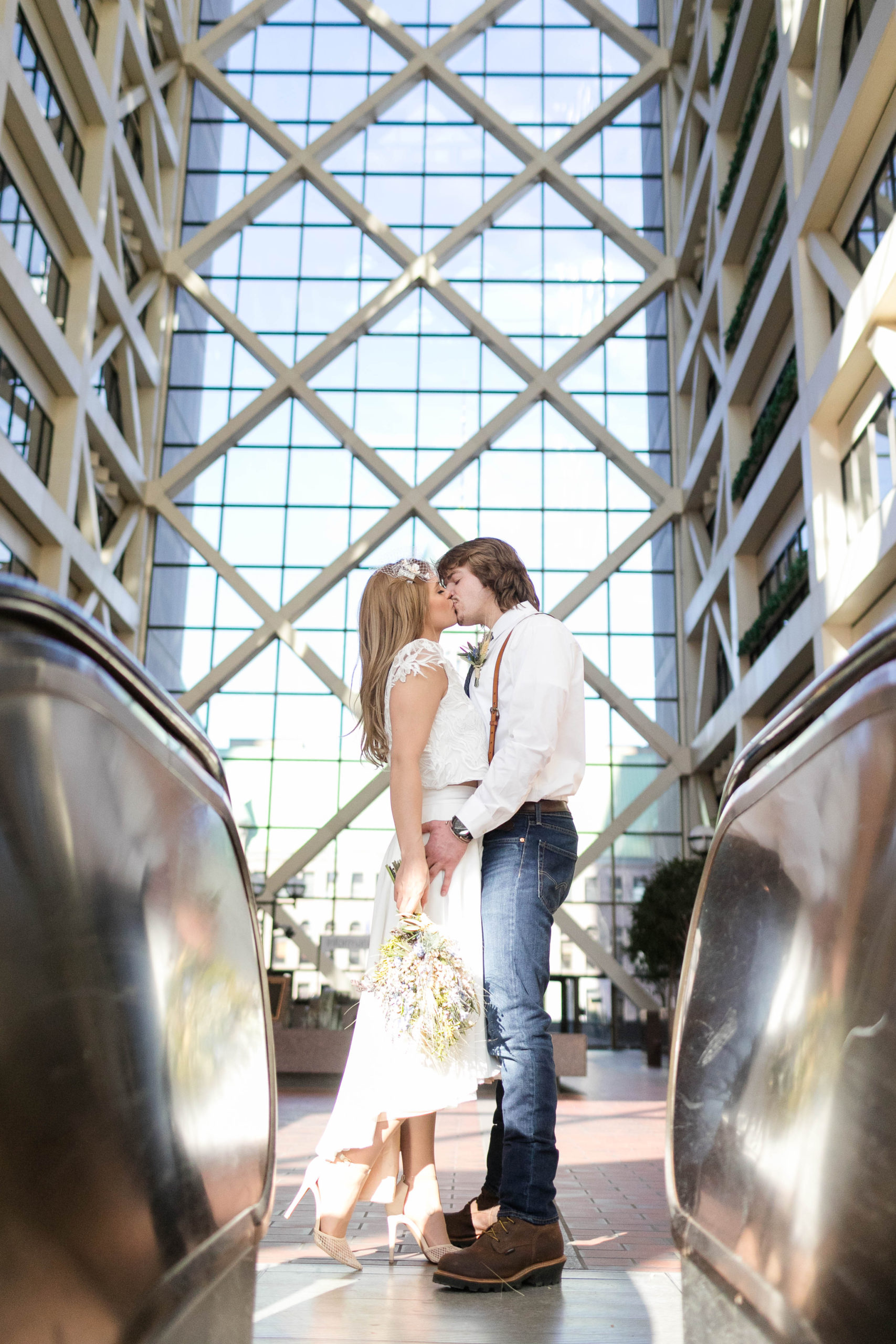 couple kissing in the atrium at the Hennepin County Government Center after having their Minneapolis courthouse wedding