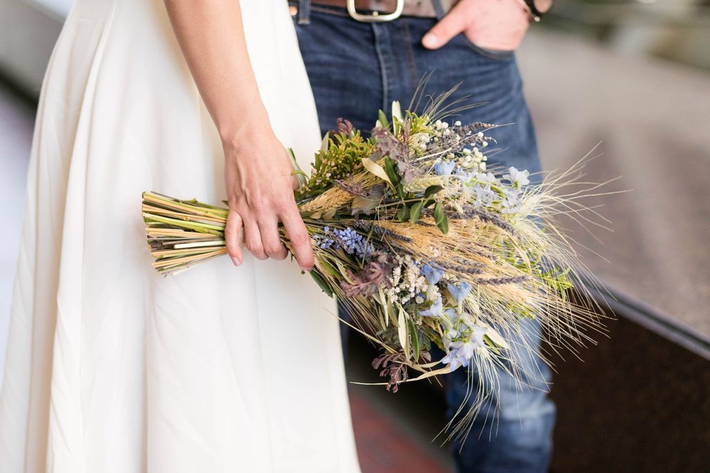 bride holding her organic bouquet by Hive & Hollow of Menomonie at the Hennepin County Government Center after having their Minneapolis courthouse wedding