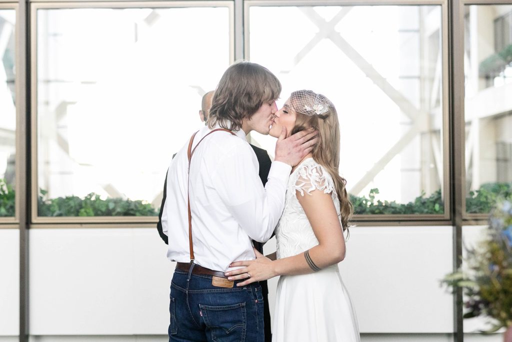 couple kissing after their ceremony at the Hennepin County Government Center after having their Minneapolis courthouse wedding