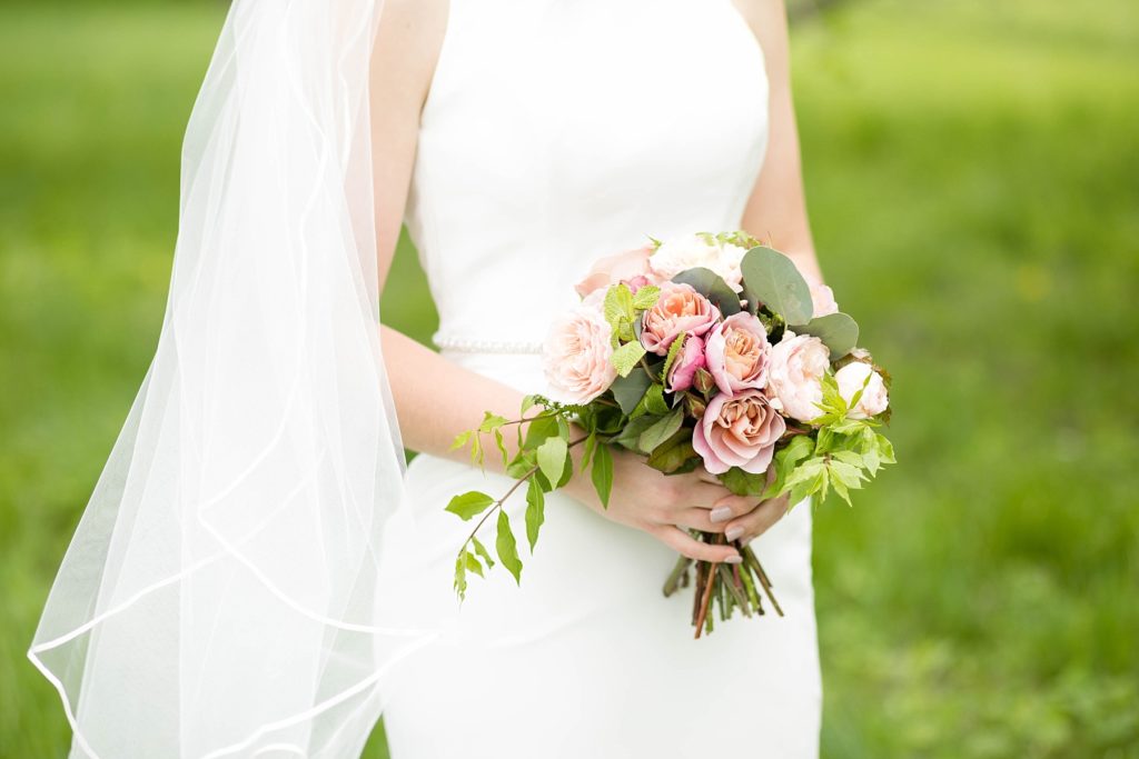 bride holding a handmade bouquet in Rice Lake, WI at Turtleback Golf