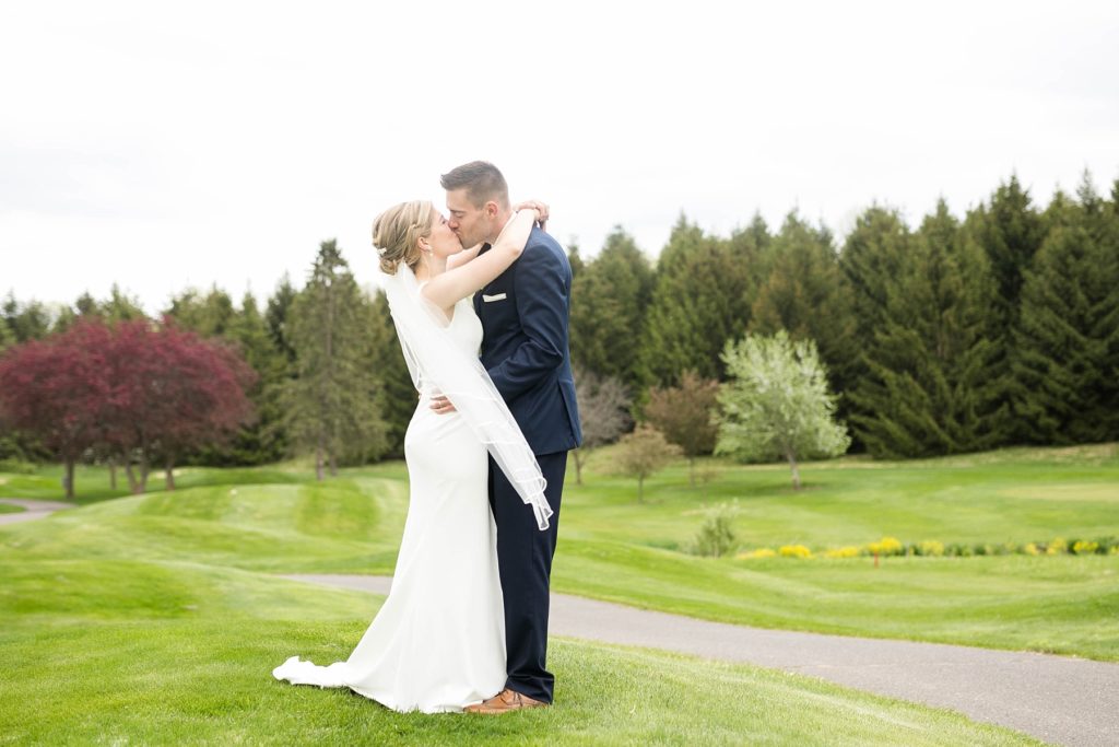 couple kissing on their wedding day in Rice Lake, WI at Turtleback Golf