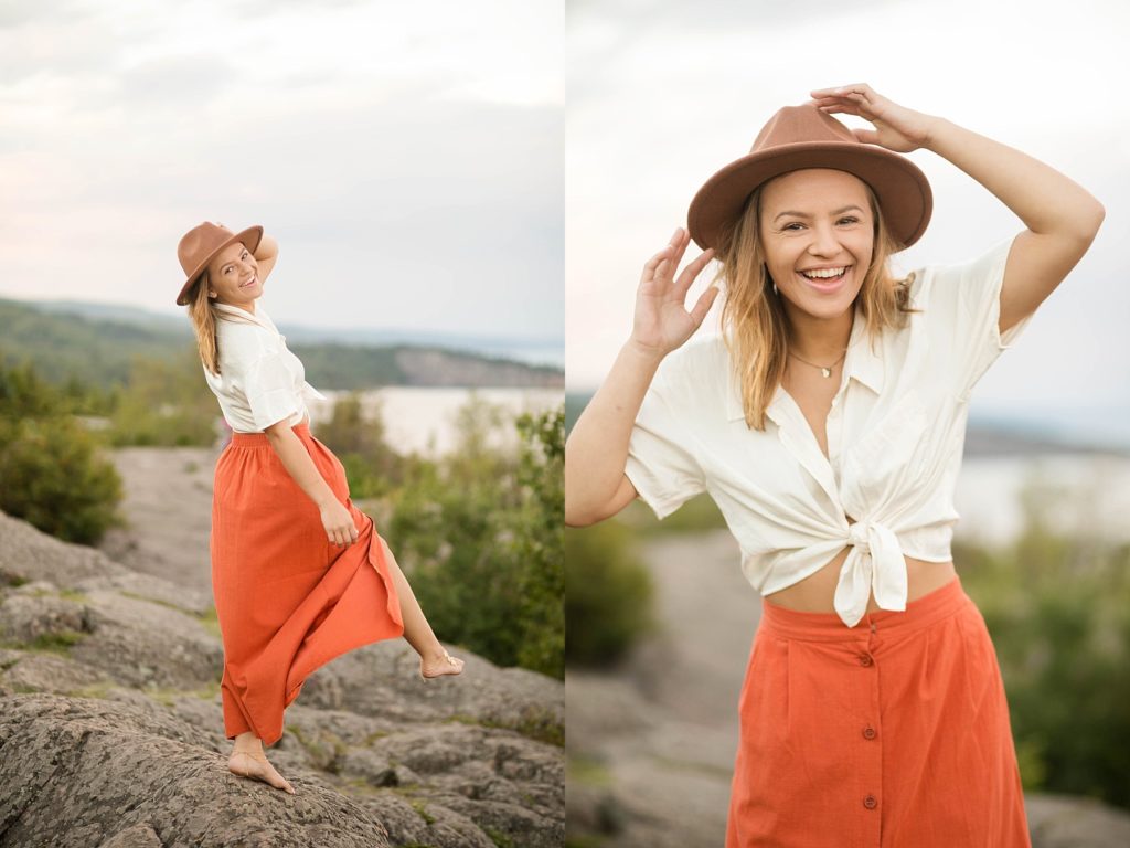 girl laughing at Palisade Head near Silver Bay, MN for her senior photos