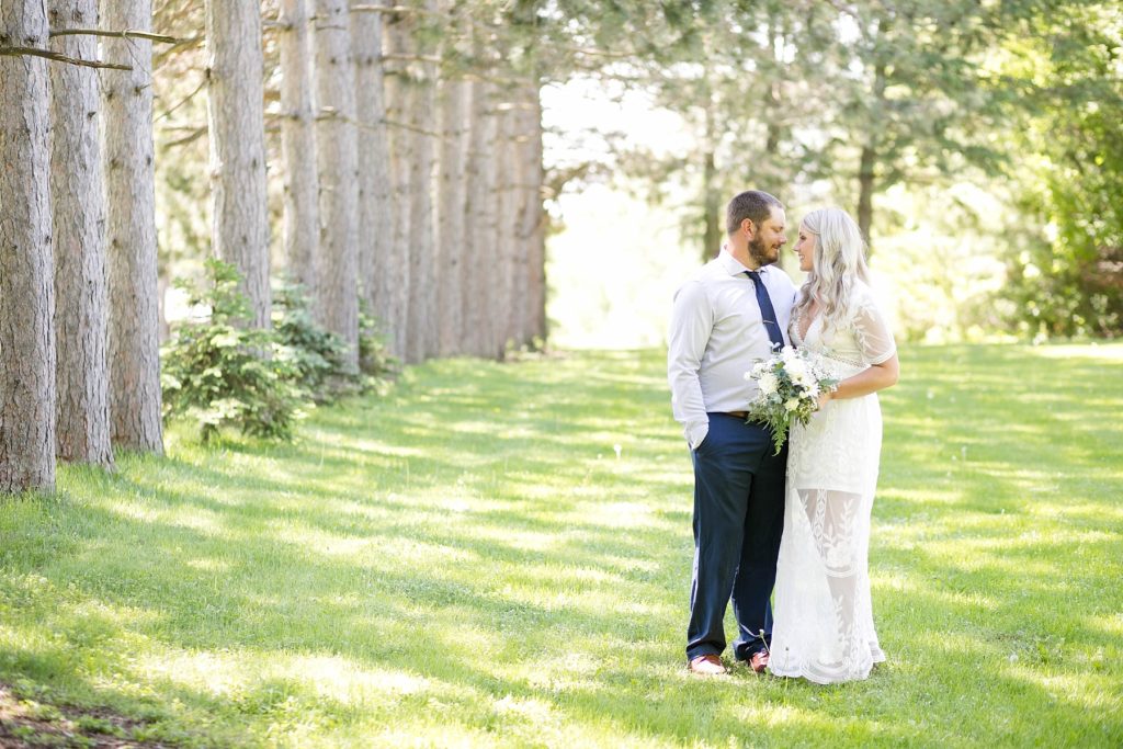 couple smiling at each other in a springtime micro wedding in Thorp, WI