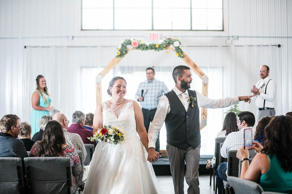 couple during the recessional at their wedding at The Mill in Chetek