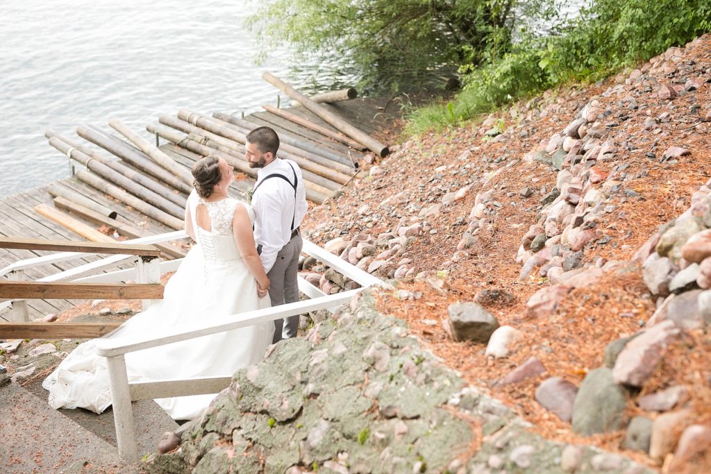 couple going down the stairs on Lake Chetek on their wedding day