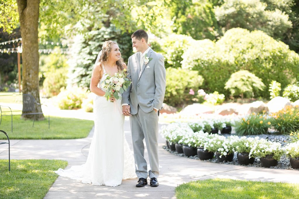couple smiling at each other for their summer wedding at The Florian Gardens in Eau Claire