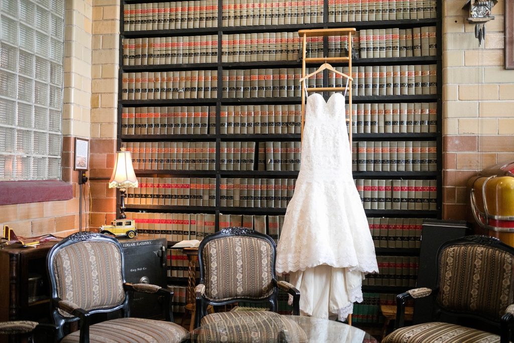 wedding at the Worden Avenue Exchange in Ladysmith WI wedding dress hanging in library