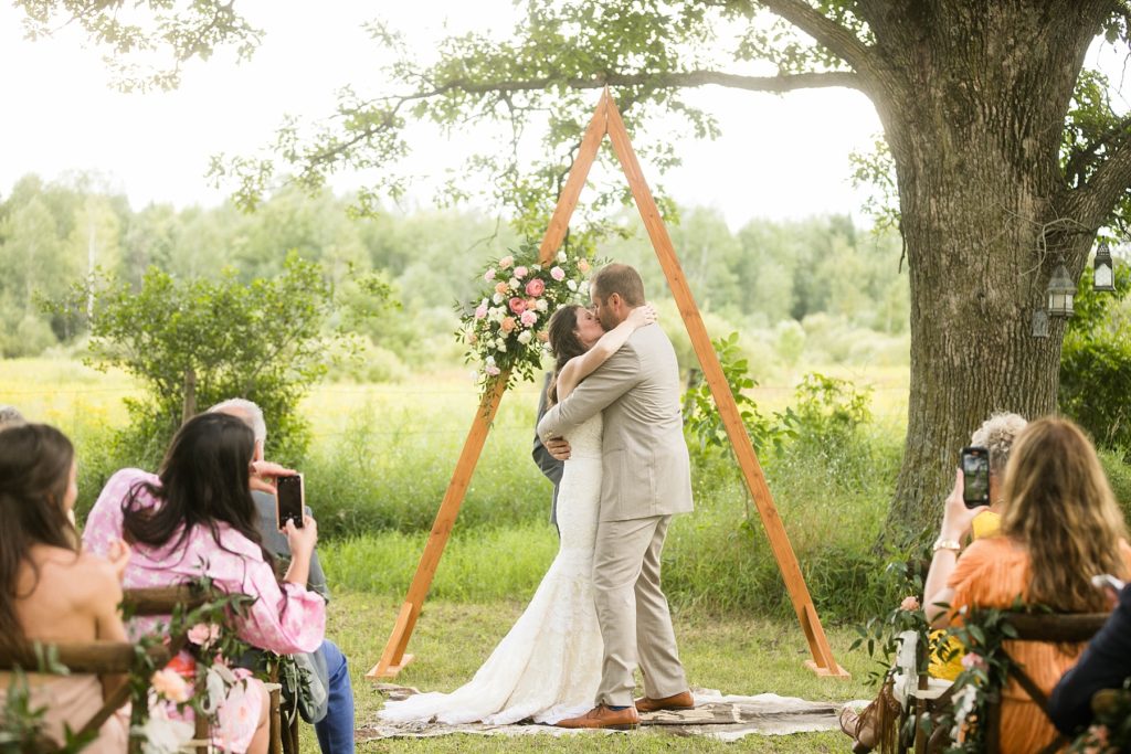 couple married in a field intimate childhood home wedding in Ladysmith, WI 