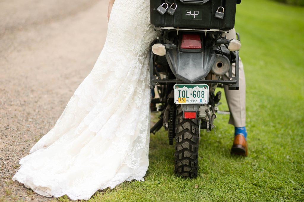 couple on motorbike with Colorado plates on their wedding day