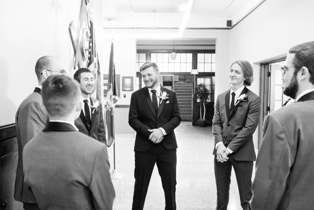 groom and groomsmen talking  at Masonic Ballroom in Eau Claire