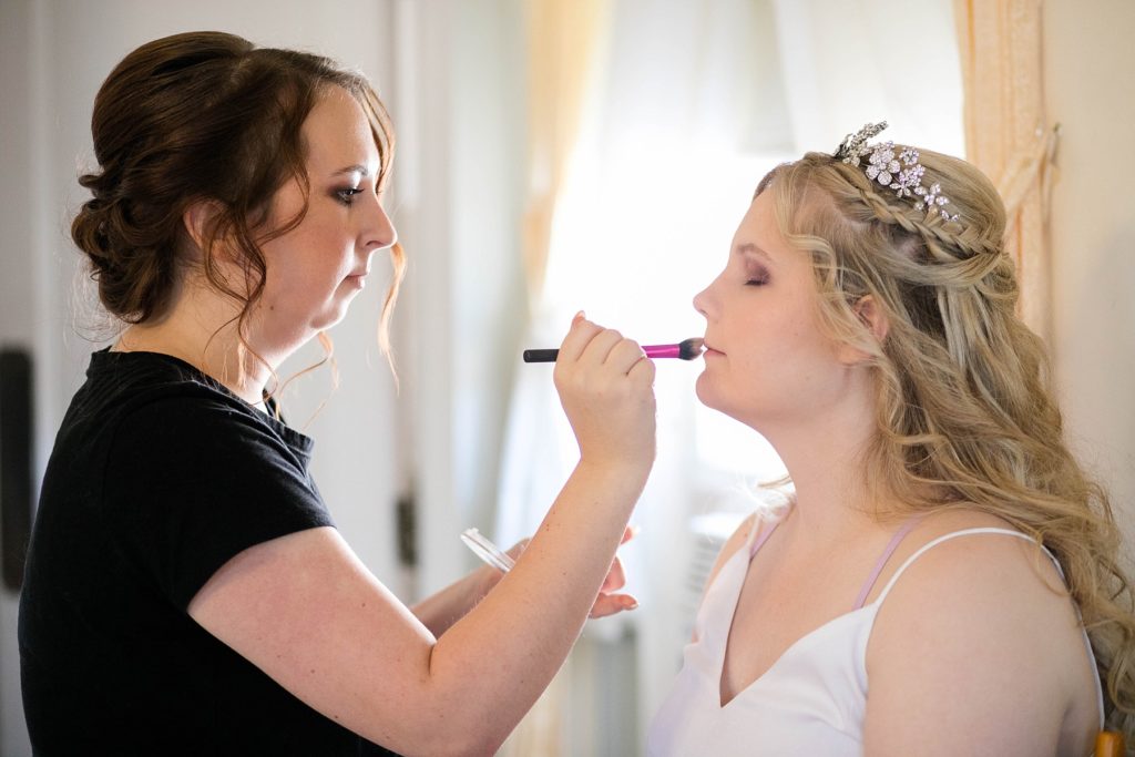 bride getting her makeup done  at Masonic Ballroom in Eau Claire