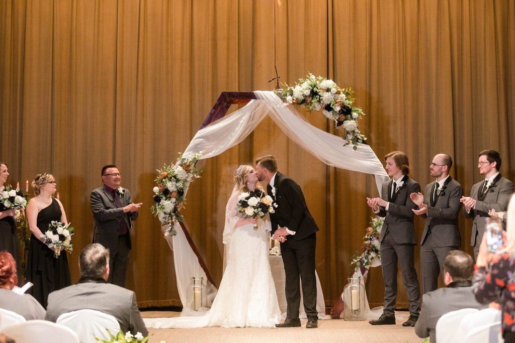 first kiss during the ceremony  at Masonic Ballroom in Eau Claire