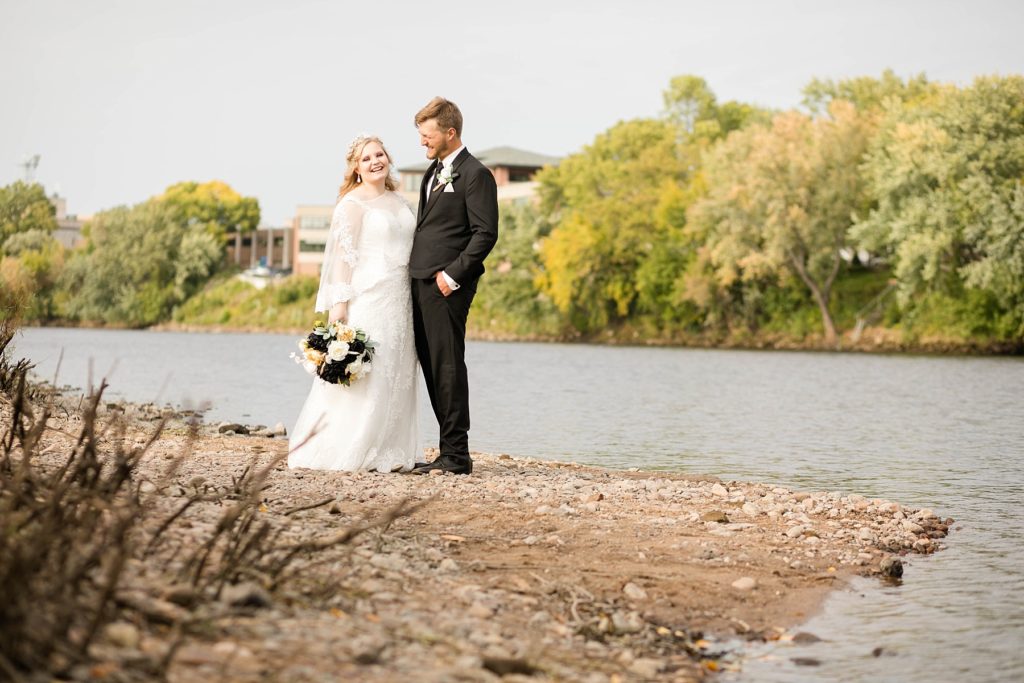 couple on the riverbank at Owen Park in Eau Claire