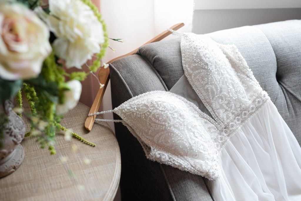 brides dress draped over a couch in the bridal suite at Lilydale in Chippewa Falls, WI