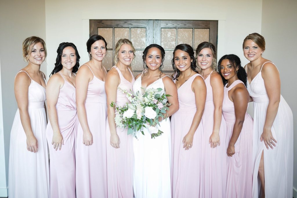 bridesmaids and bride smiling at the camera in the bridal suite at Lilydale in Chippewa Falls, WI