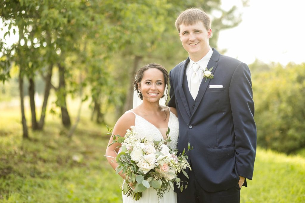 couple smiling at the camera on their wedding day at Lilydale in Chippewa Falls, WI