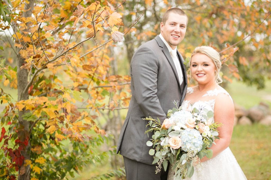 couple smile during their first look outside at Lilydale in Chippewa Falls during their fall wedding