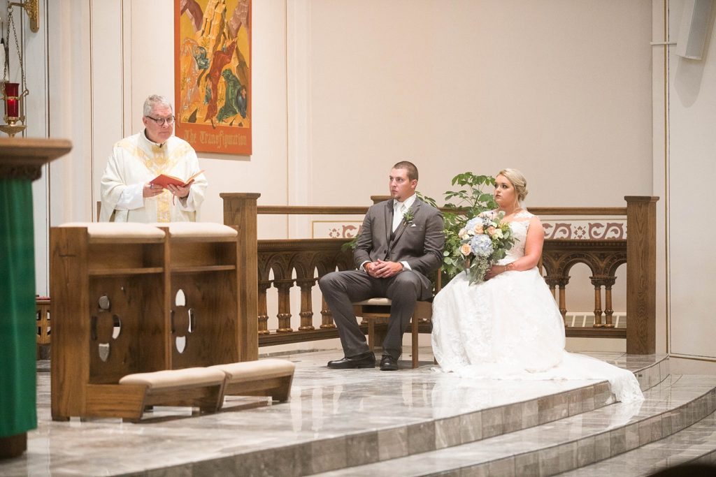 couple sitting at St. Charles of Borromeo in Chippewa Falls for their wedding
