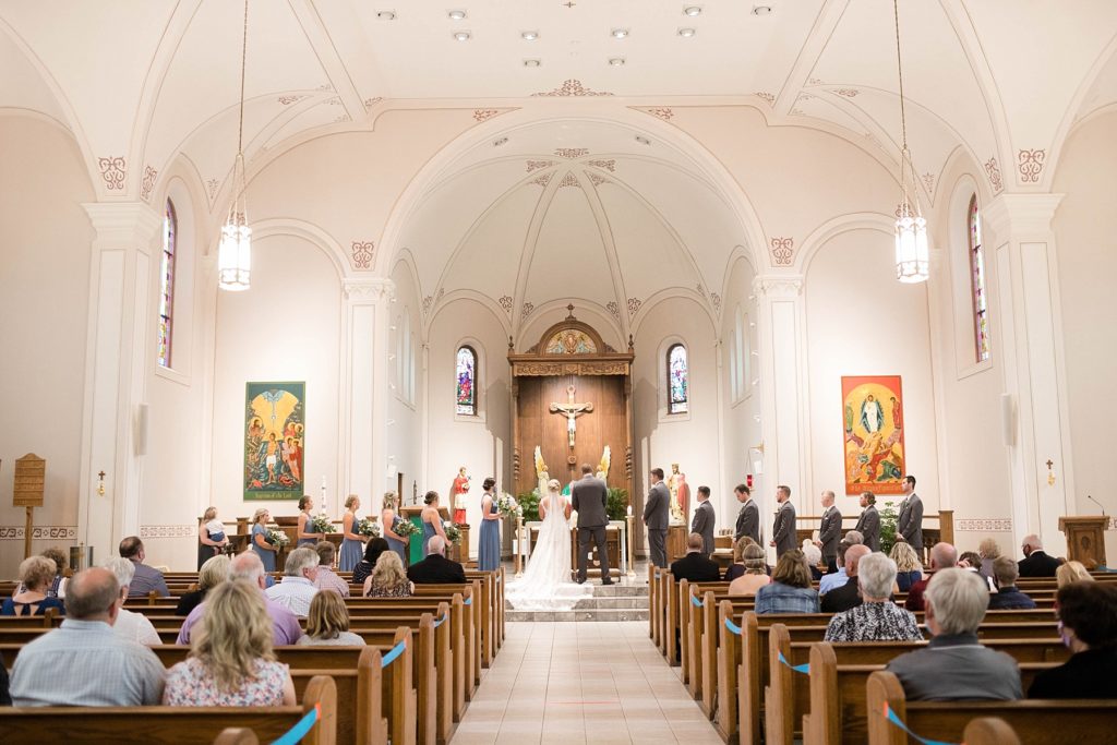 couple during wedding rites at St. Charles of Borromeo in Chippewa Falls for their wedding