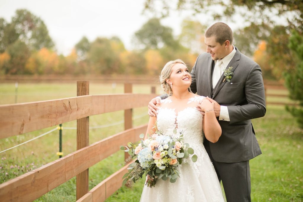 couple smile at each other at their fall wedding at Lilydale in Chippewa Falls