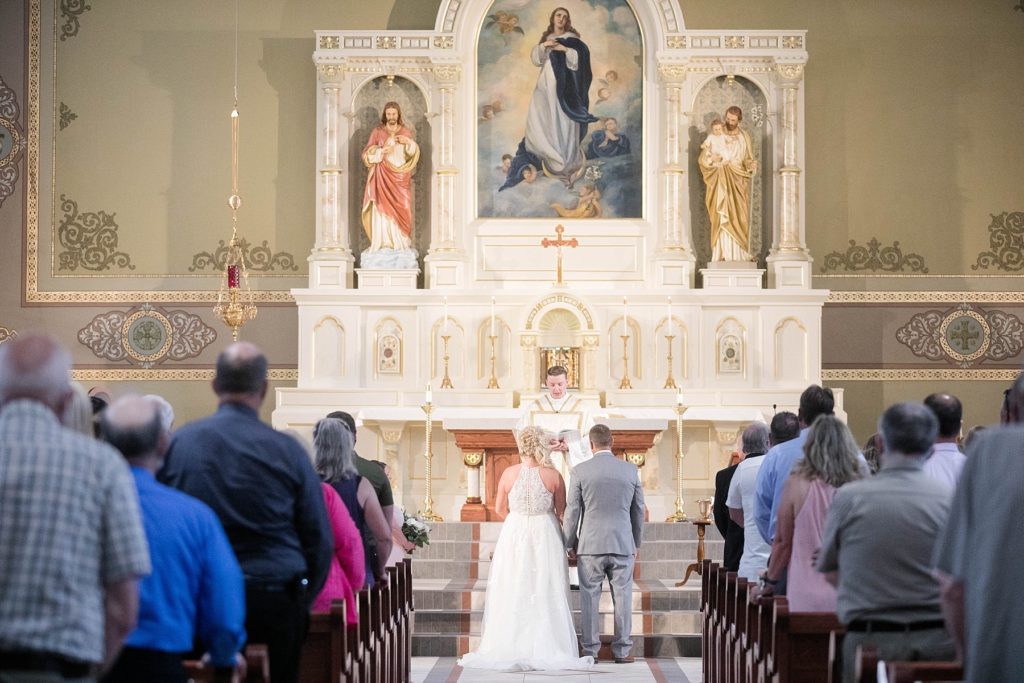 bride and groom at ceremony at Notre Dame Catholic Church in Chippewa Falls