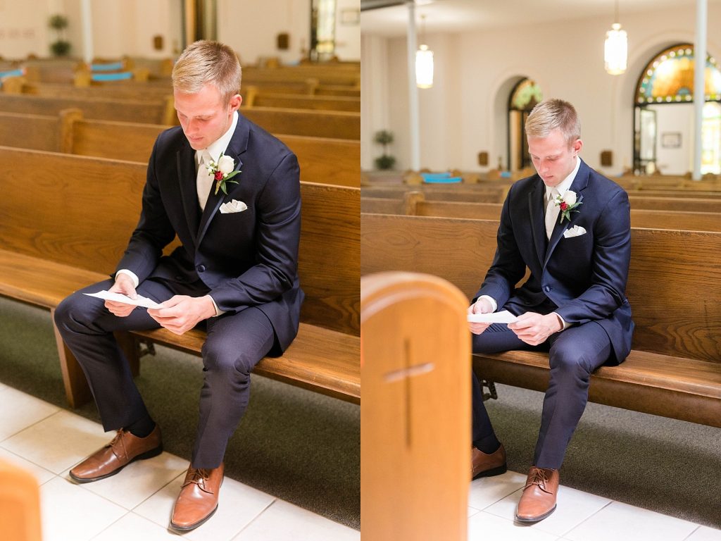 groom reading his letter from the bride in a church pew at St. Charles Borromeo Catholic Church in Chippewa Falls