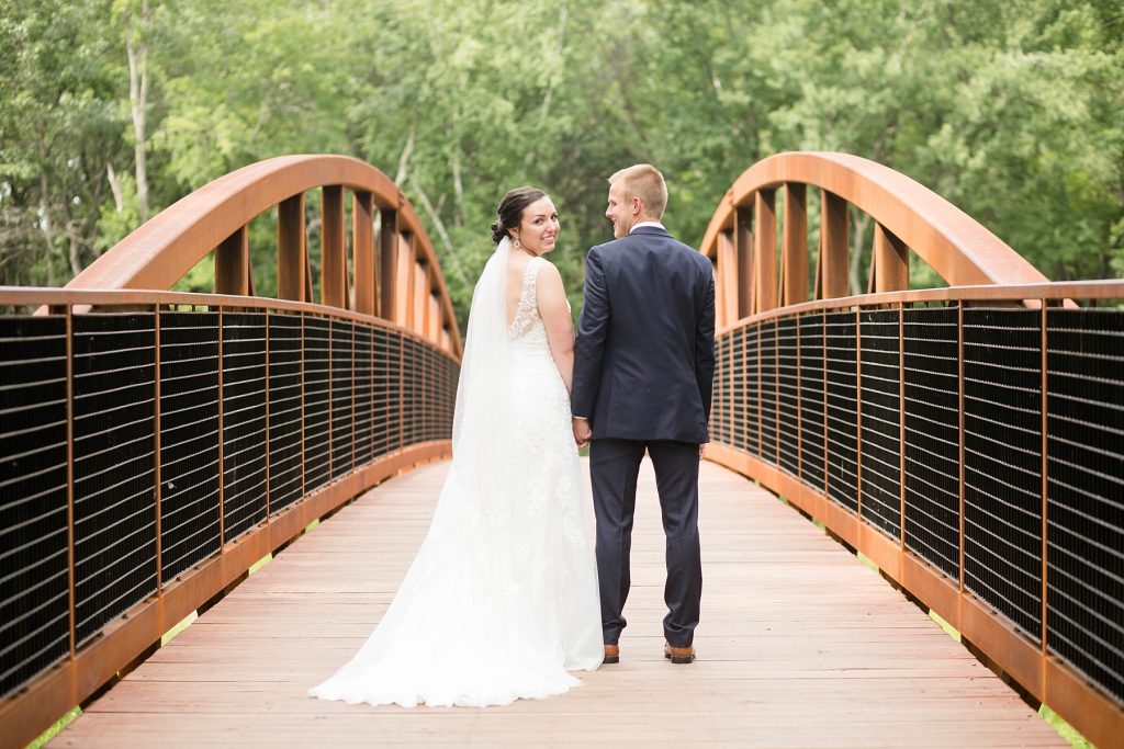 bride and groom on bridge at Erickson Park in Chippewa Falls