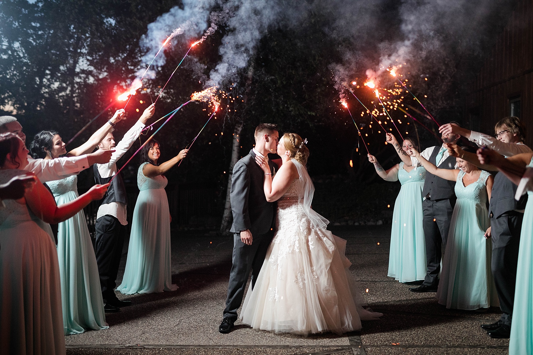 couple kissing under sparklers at Pettibone Resort wedding in La Crosse WI