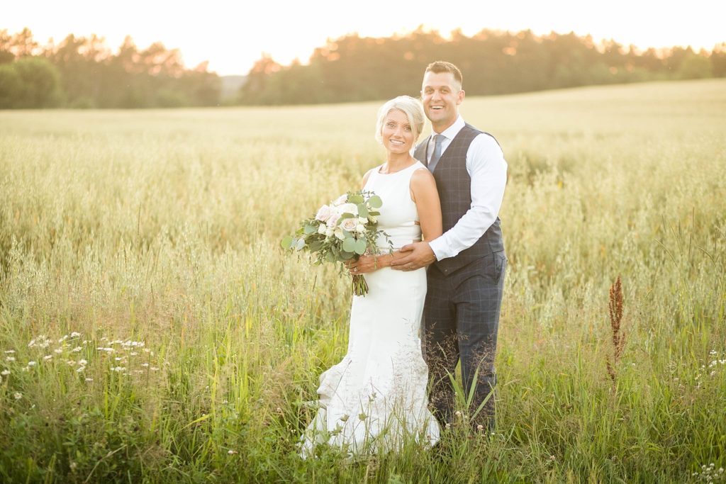 bride and groom in a field before sunset at Lilydale Dance Hall & Event Venue in Chippewa Falls