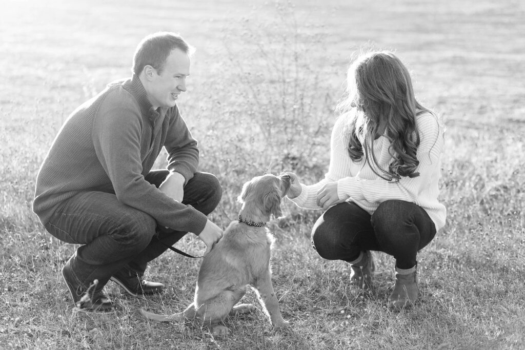 couple feeding puppy treats for their Eau Claire couples session with new puppy