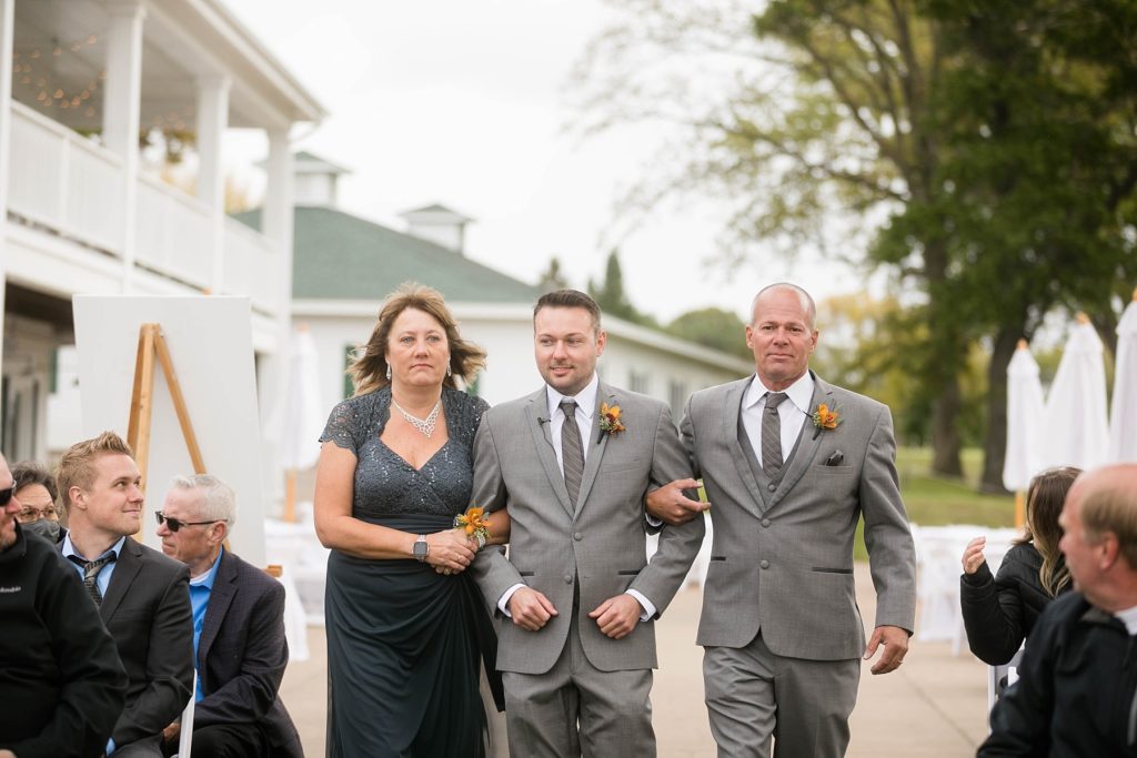 groom walking down the aisle during an outdoor ceremony at a wedding at Lake Wissota Golf & Events