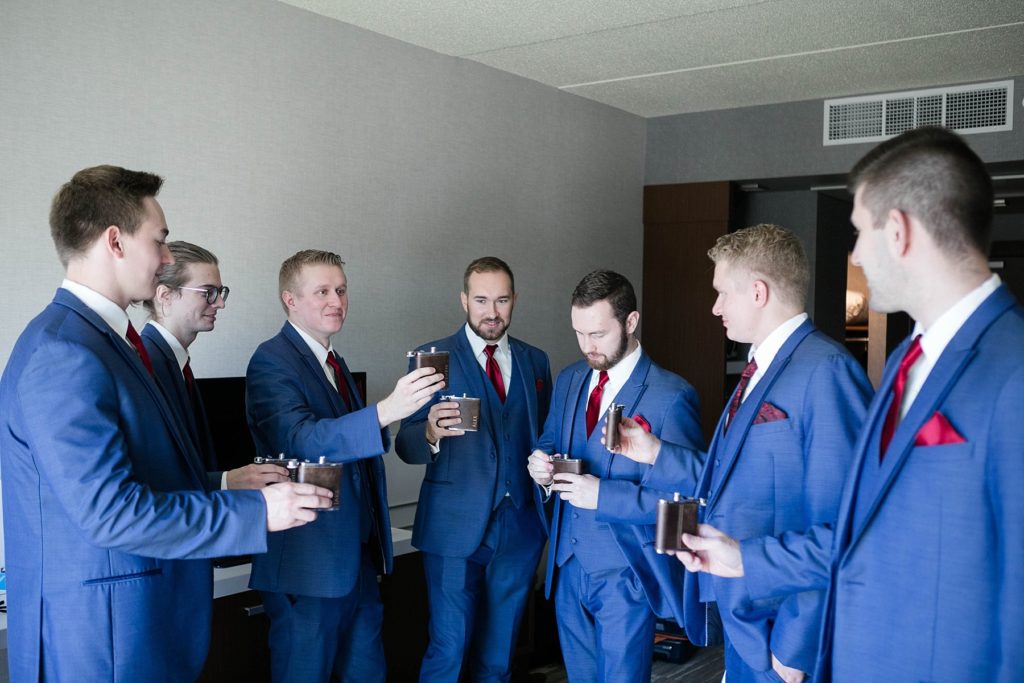 groomsmen toasting with flasks before stunning wedding in Marathon, WI