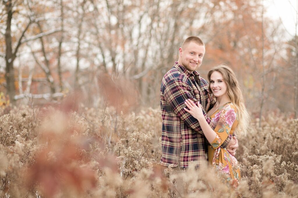 couple standing in tall grasses in Ladysmith for fall engagement photos