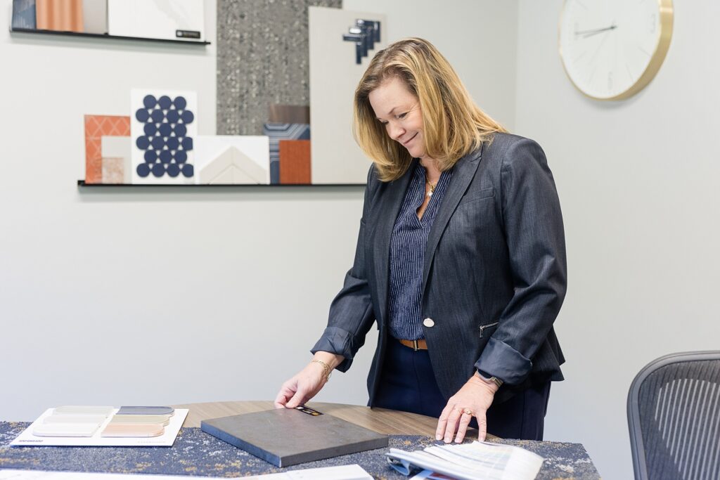 woman looking at design samples in an office at River Valley Architects in Eau Claire, WI